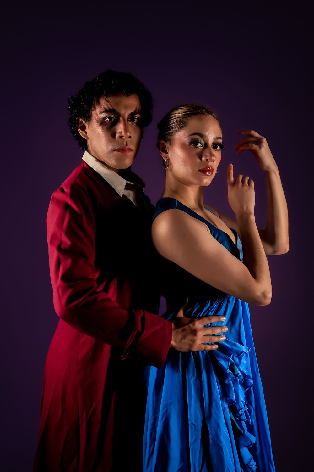 A dancer in a blue gown under stage lights