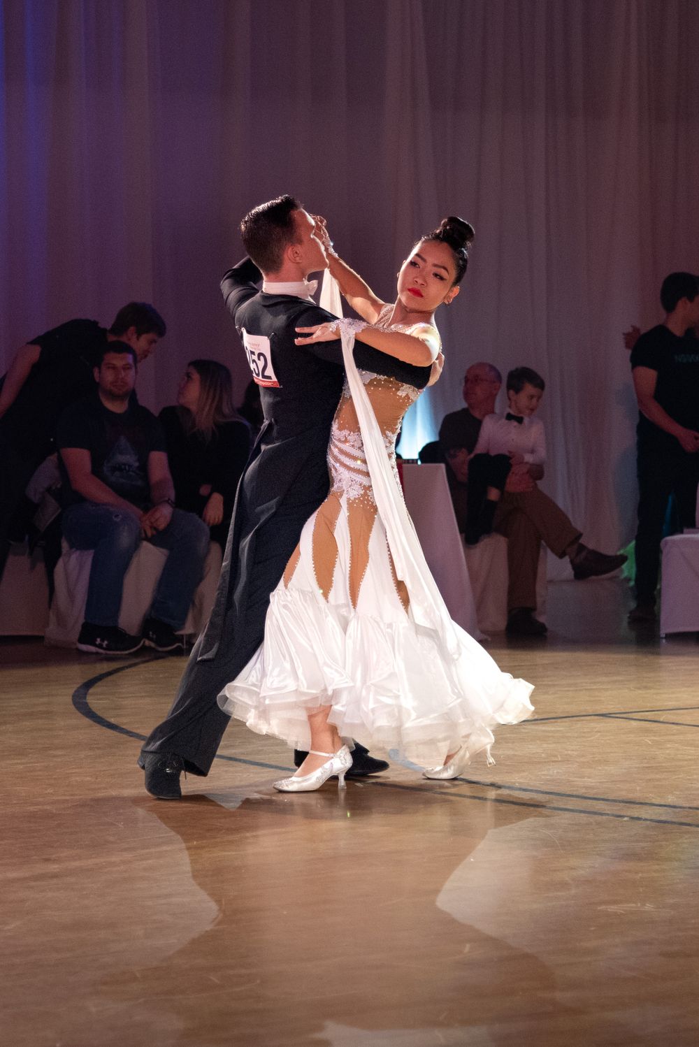 A competitive ballroom couple on the floor